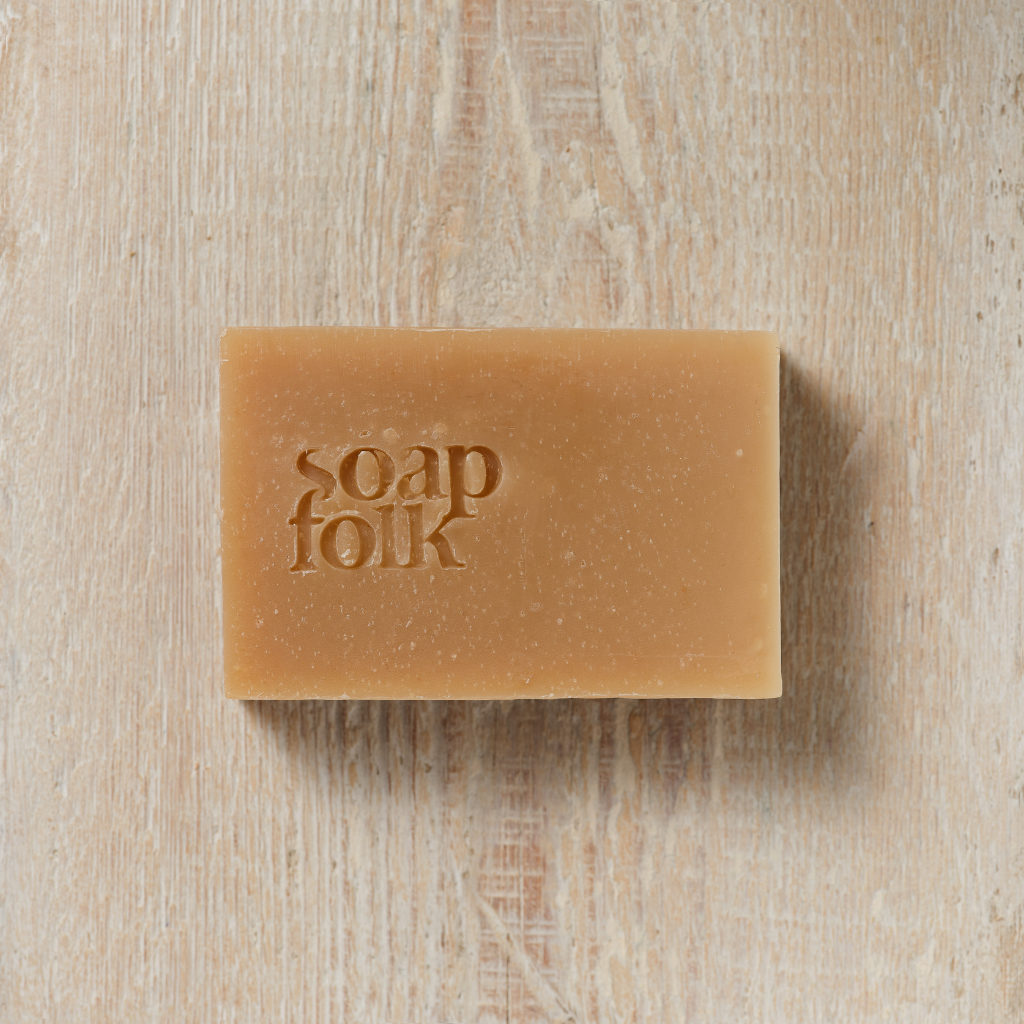Bar of Spiced Apple soap with 'soap folk' branding on a wooden surface
