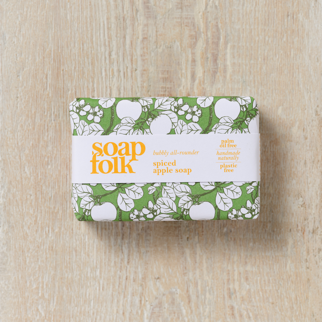 Bar of Spiced Apple soap with 'Soap Folk' packaging on a wooden surface