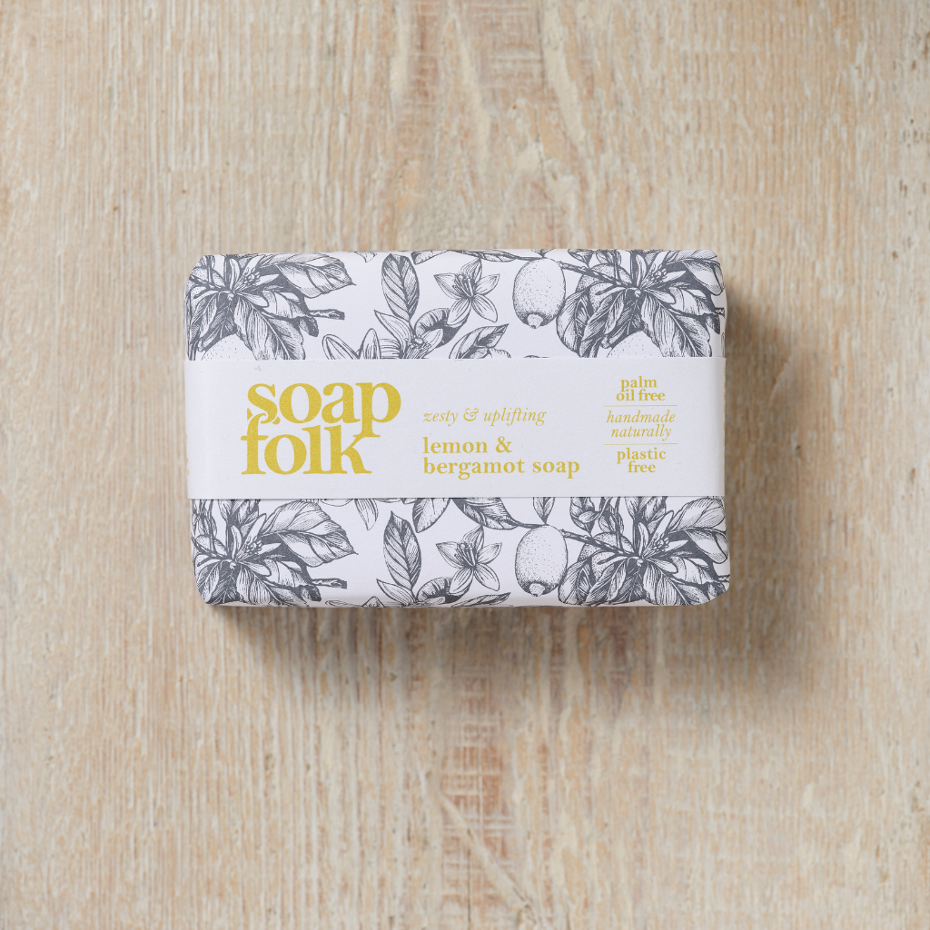Bar of Lemon and Bergamot soap with 'soap folk' packaging on a wooden surface.